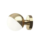 Louis Poulsen VL Studio wall lamp in brass, opal glass globe diffuser partially covered by a hemispherical brass shell on a short stem and circular wall plate, three quarter view.