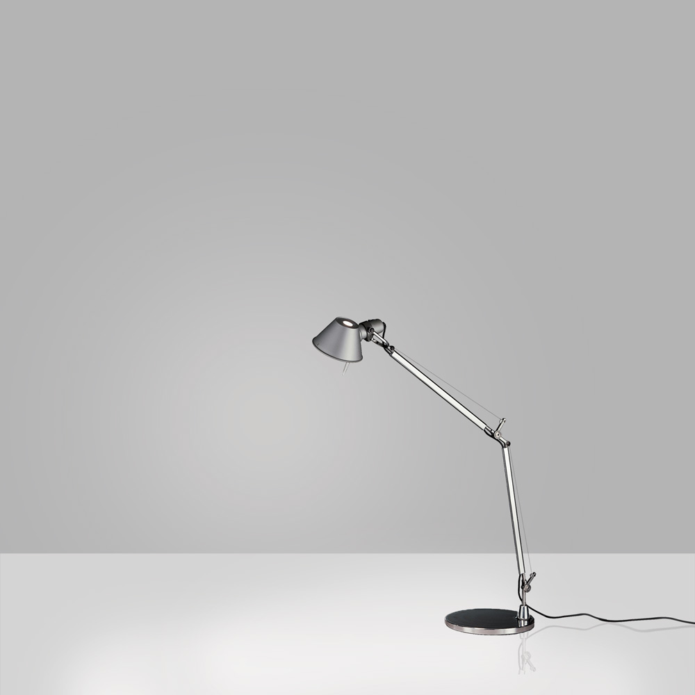 Artemide Tolomeo Mini table lamp in polished aluminum, smaller scale articulated arm and conical shade on a circular weighted tabletop base, three quarter view.