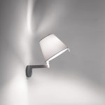 Artemide Melampo wall lamp in white, tilting fabric tapered shade on a slim arm extending from a small disc wall plate, three quarter view.